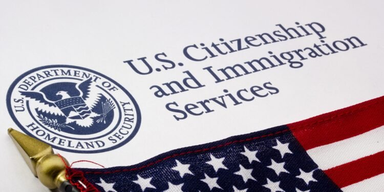 close-up-on-uscis-and-flag-scaled-1-750x375